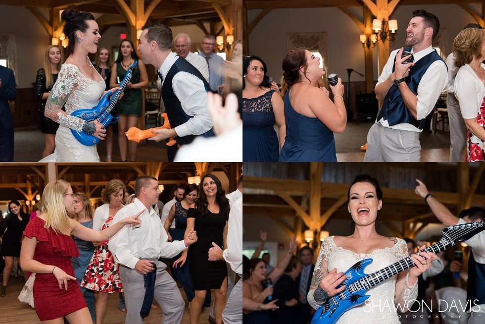 Wedding reception dancers with a blue inflatable guitar at a decorated indoor venue