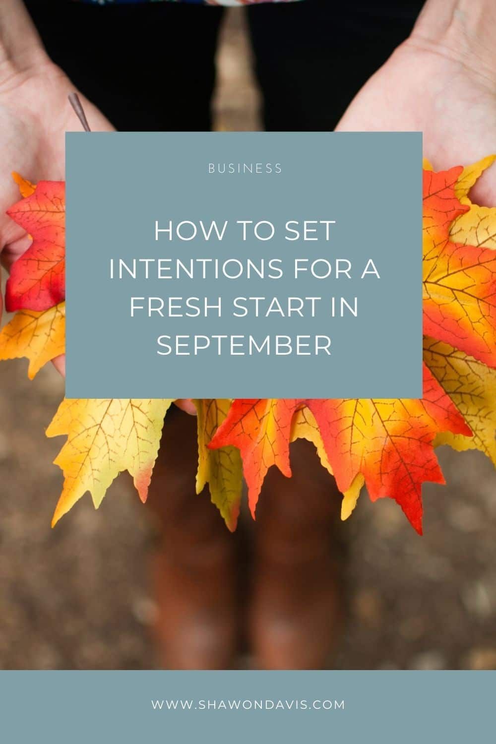 Hands holding autumn leaves behind a teal card reading “How to set intentions for a fresh start in September”
