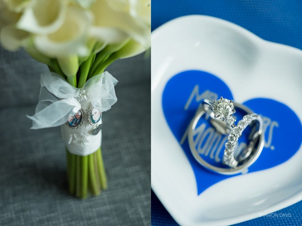 Wedding rings on a white heart-shaped dish beside a bouquet of white flowers