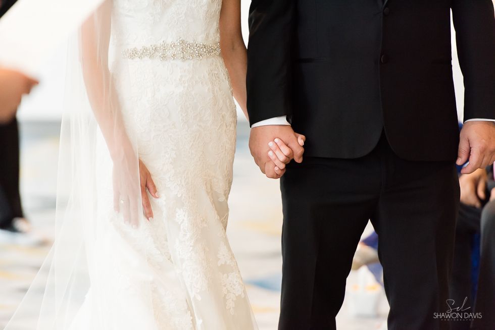 Bride and groom holding hands at a wedding ceremony