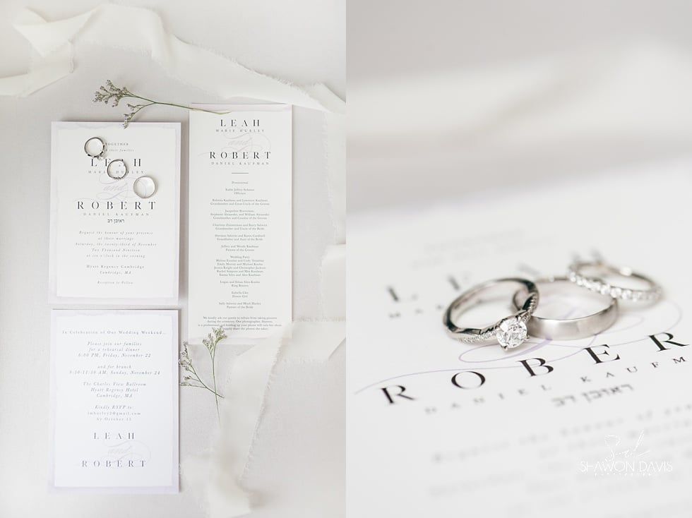 White wedding invitation suite with silver rings on a soft, minimal background