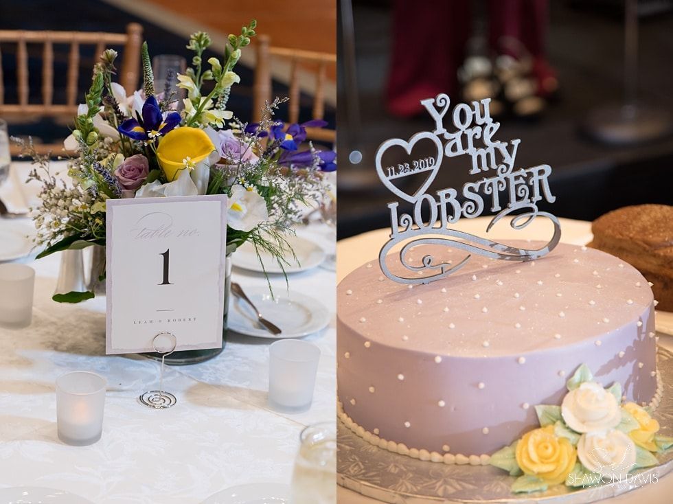 Decorated wedding reception table with floral centerpiece, table number, and pink cake topper reading “You are my lobster”
