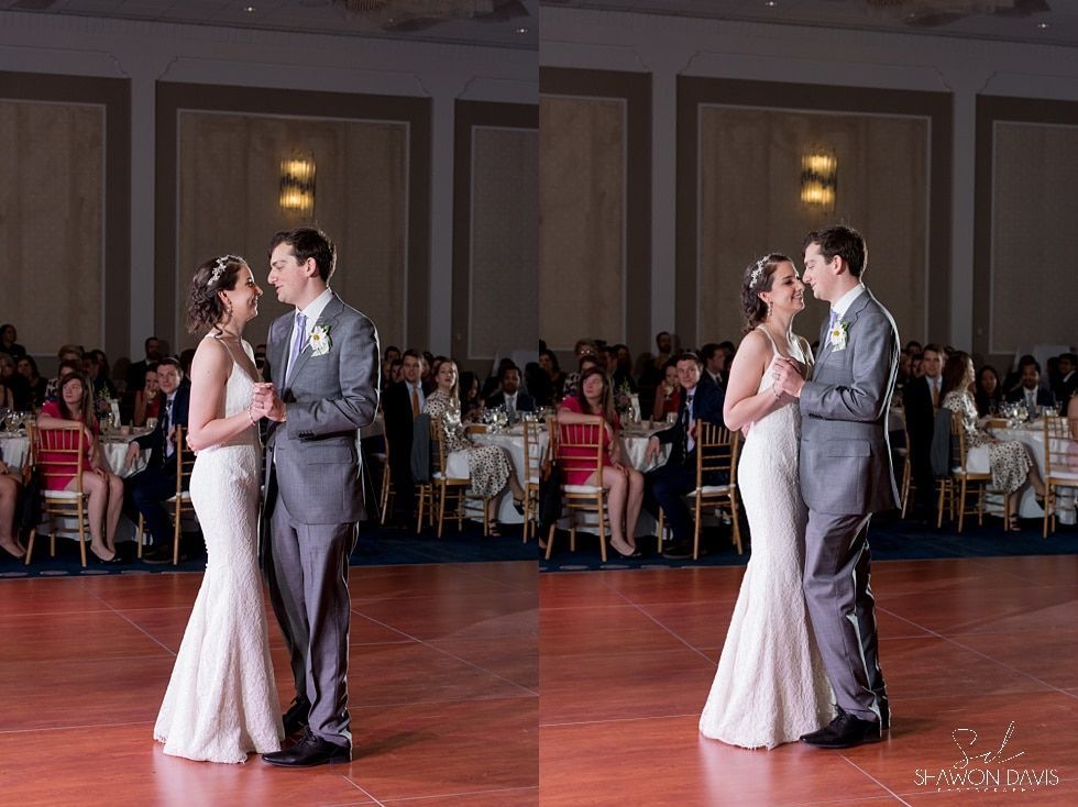 Couple in formal attire slow dancing at a reception hall during a wedding