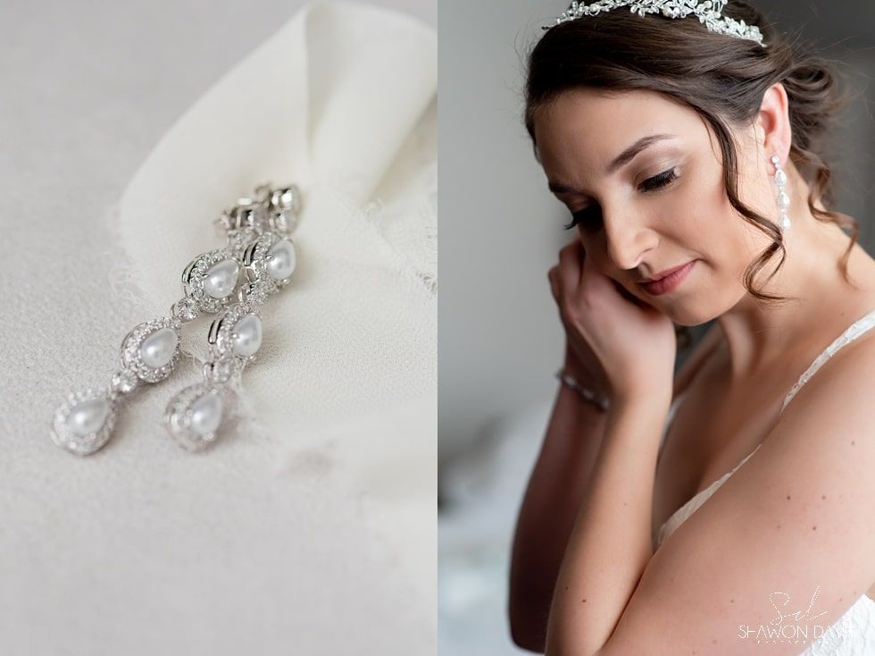 Bride in white dress with jeweled hairpiece, resting her head on her hand against a soft white background