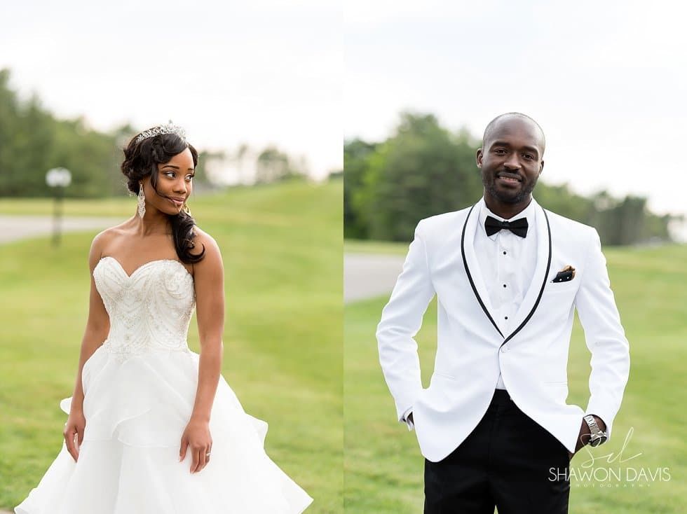 Bride and groom in white wedding attire walking together on a grassy field