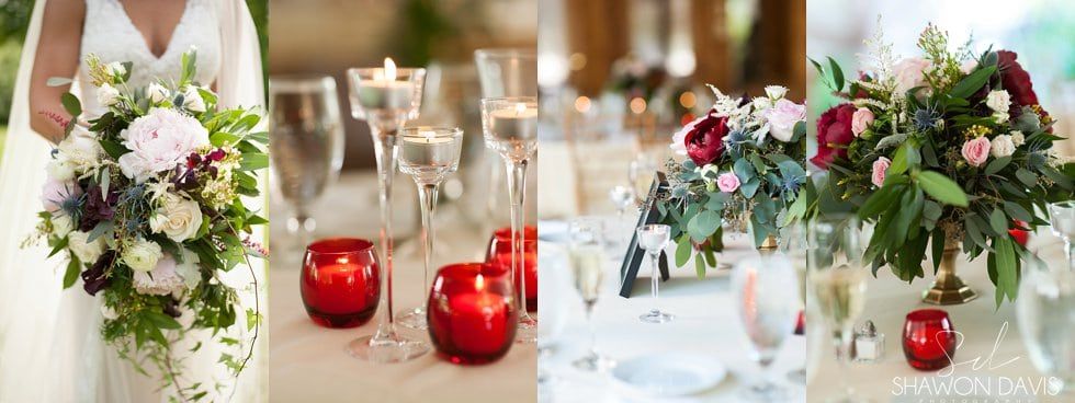 Wedding reception table with white floral centerpieces, red candles, and champagne glasses