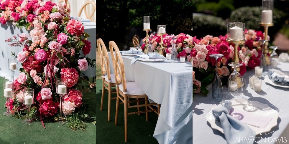 Pink and white floral wedding table decor with candles on a garden lawn