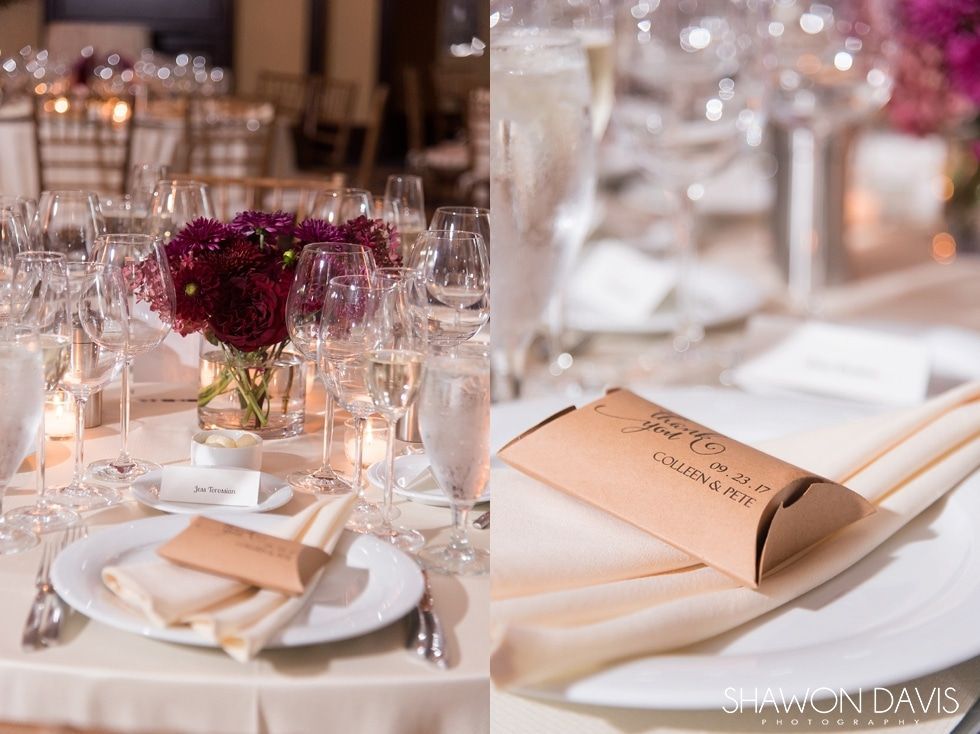 Elegant banquet table set with wine glasses, candles, and folded cream napkins with menu cards