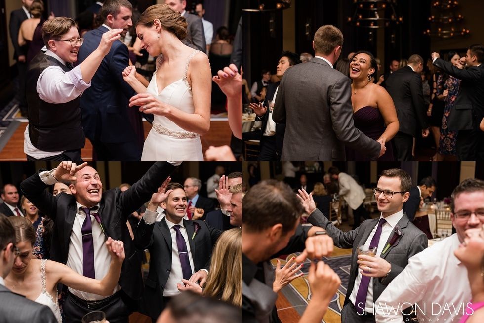 Wedding reception guests dancing and laughing under warm lights, with the bride and groom celebrating nearby