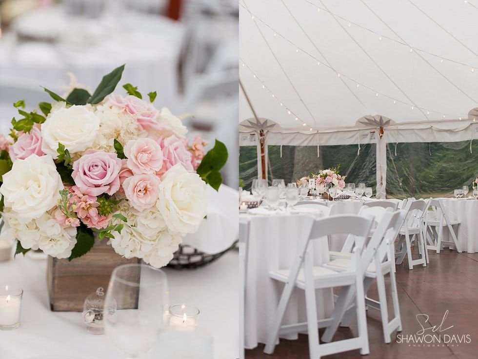 White wedding reception tent with blush roses centerpiece, long tables, and white chairs
