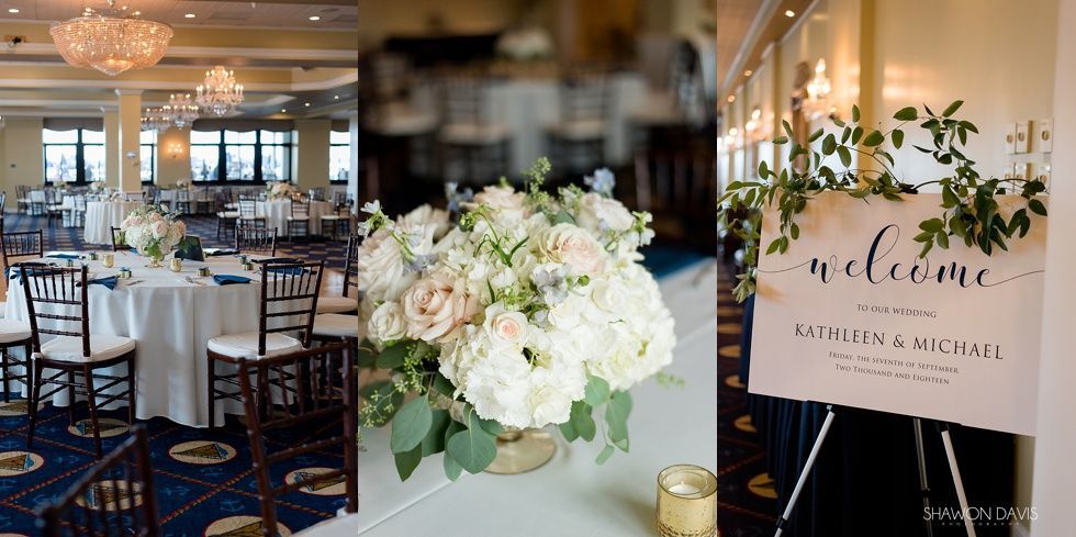 Elegant wedding reception decor with white florals, lit tables, and a welcome sign with greenery