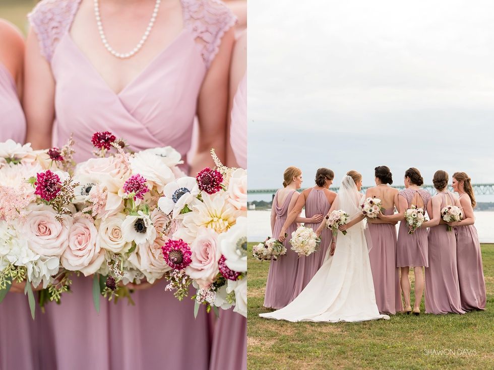 Bridesmaids in lavender dresses holding pastel flower bouquets at an outdoor wedding with the bride.