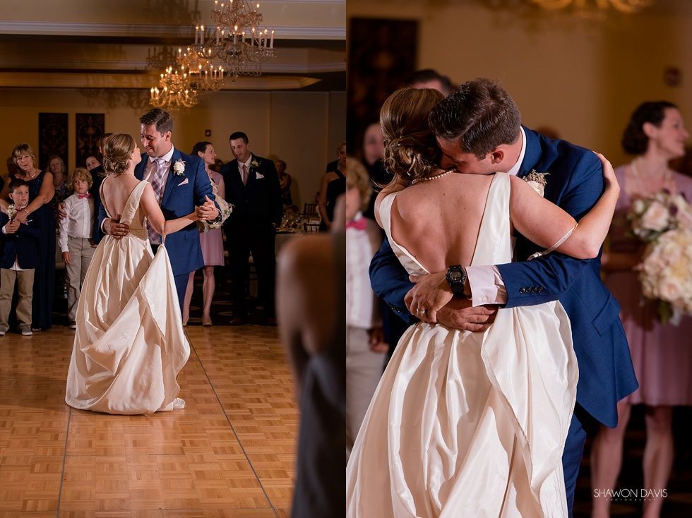 Couple slow-dancing at a wedding reception in a warmly lit banquet hall