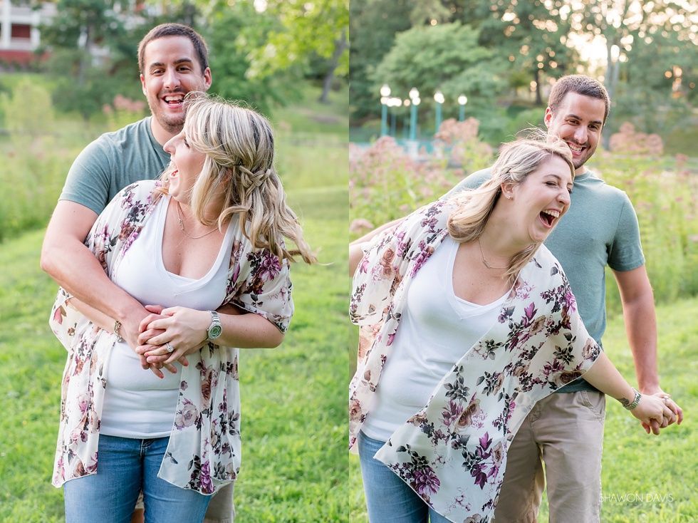 Two couples laughing and posing in a grassy park, with one pair leaning playfully back to back