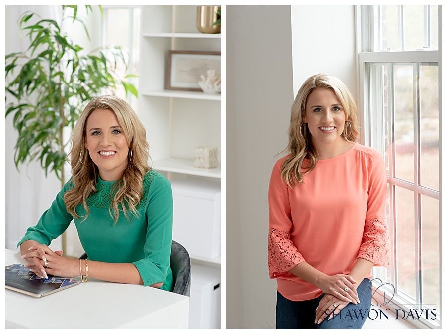 Woman in teal and coral tops posing in a bright office by a window and desk