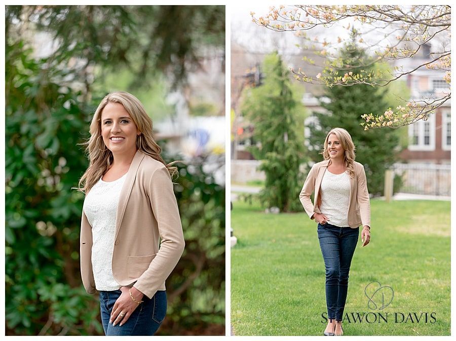 Woman smiling outdoors on a green lawn, wearing a beige cardigan, white top, and jeans.