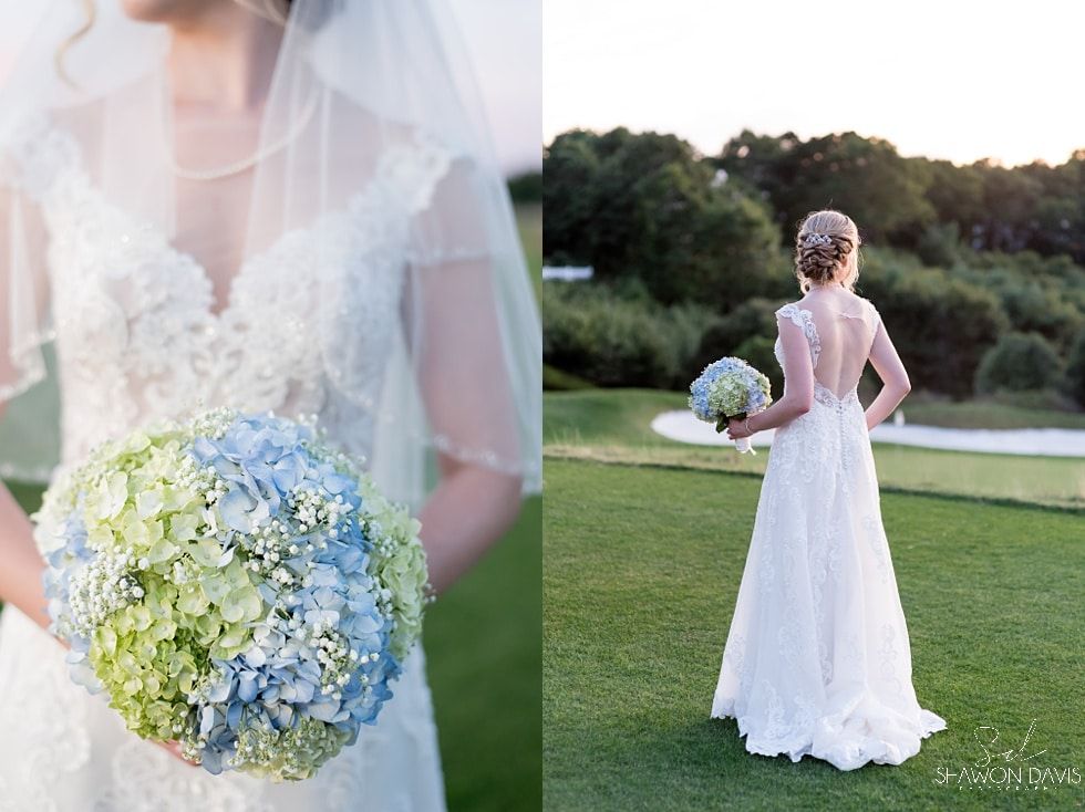 Bride in a white gown holding a blue and green bouquet outdoors on a lawn at sunset