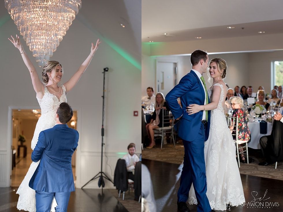 Bride and groom kiss at a wedding reception as a child reaches toward the bride on the dance floor.