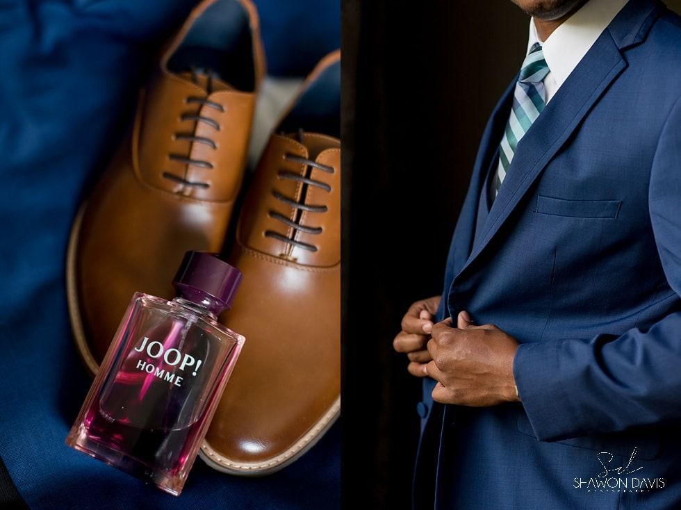 Brown dress shoes and a purple Joop! cologne bottle beside a man in a blue suit and striped tie