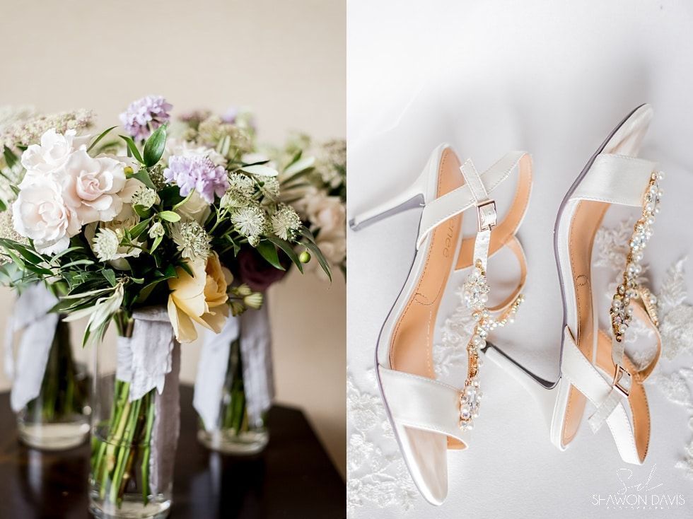 Wedding bouquet beside white bridal heels with crystal embellishments