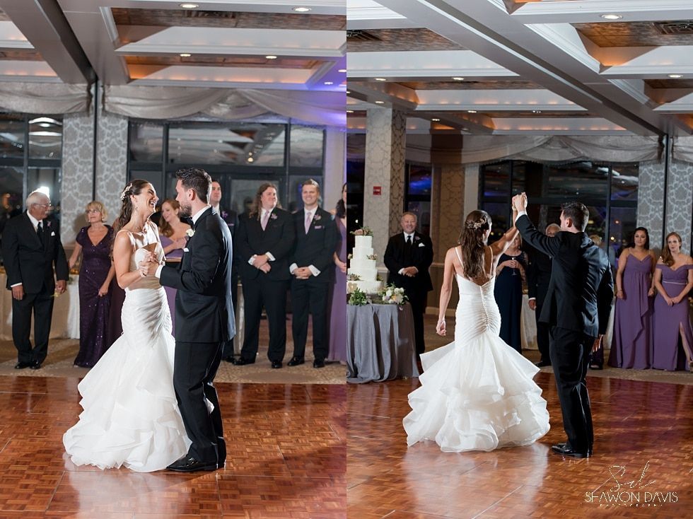 Two brides and two grooms dancing in a decorated wedding hall with guests watching.