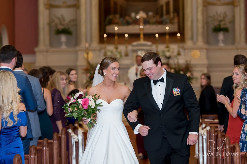 Bride and groom walking down church aisle after their wedding ceremony