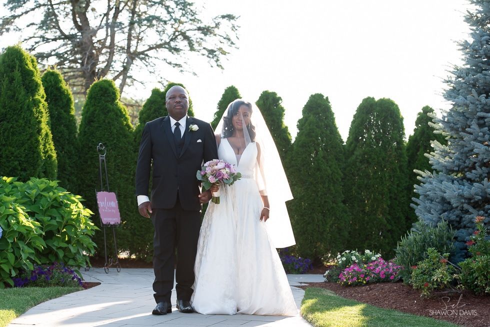 Bride and groom standing together in a garden wedding ceremony