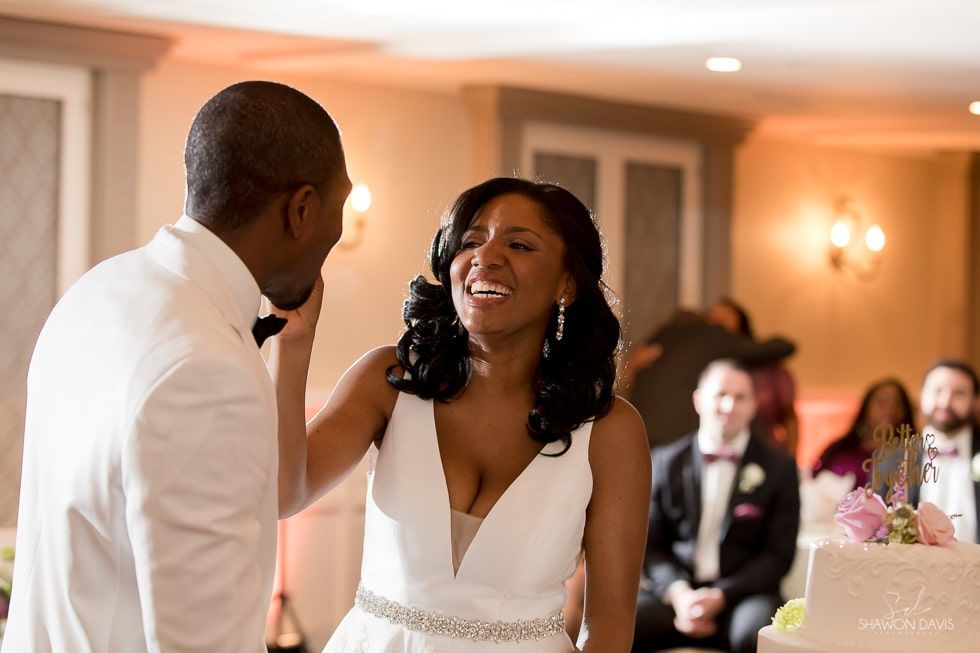 Bride and groom sharing a joyful moment during their wedding reception