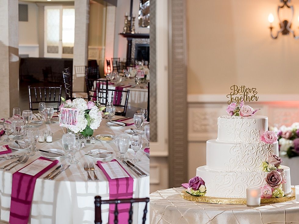 Elegant wedding reception table with pink accents and a white tiered cake on a gold stand