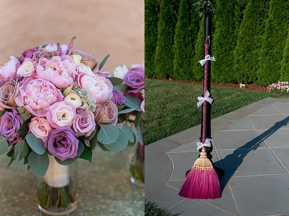 Pink and lavender rose bouquet beside a pink broom standing on a sidewalk outdoors