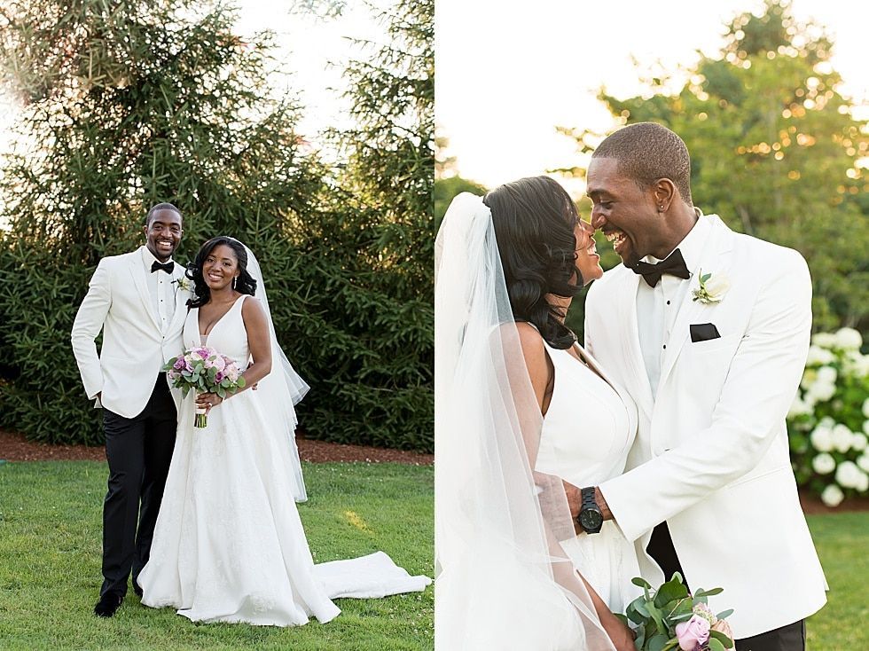 Bride and groom in white tuxedos kiss at an outdoor wedding with bridesmaid and groomsman nearby