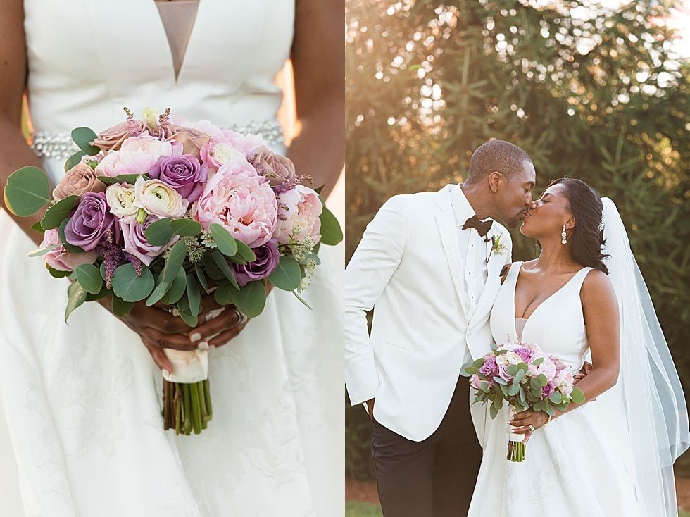 Bride holding pink bouquet beside groom kissing her on wedding day outdoors at sunset