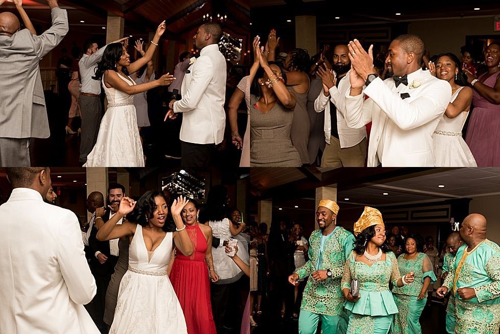 Wedding guests dancing and clapping at a reception, with a white-clad couple and guests in colorful outfits