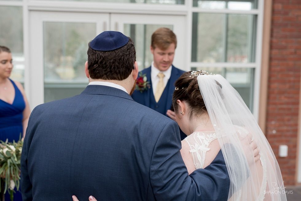 Bride and groom sharing a kiss at an outdoor wedding ceremony