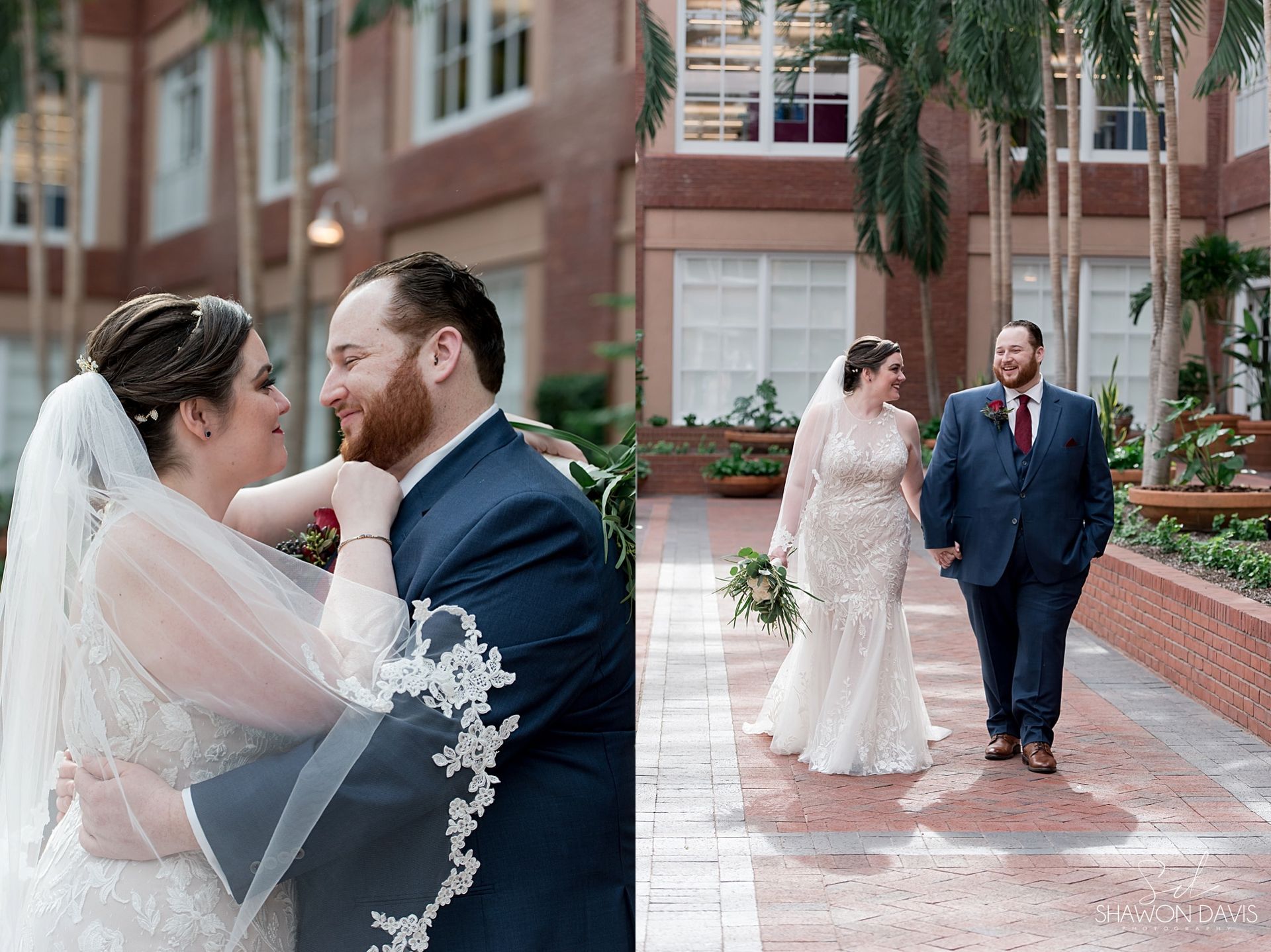 Two couples in wedding attire pose and walk beside a brick building on a wet sidewalk