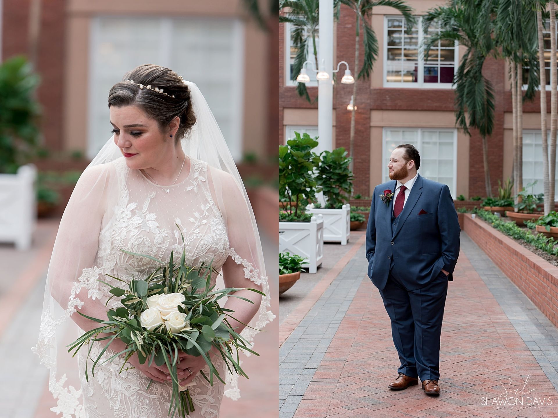 Bride in white gown holding bouquet looks away while groom in navy suit stands behind on a brick walkway.
