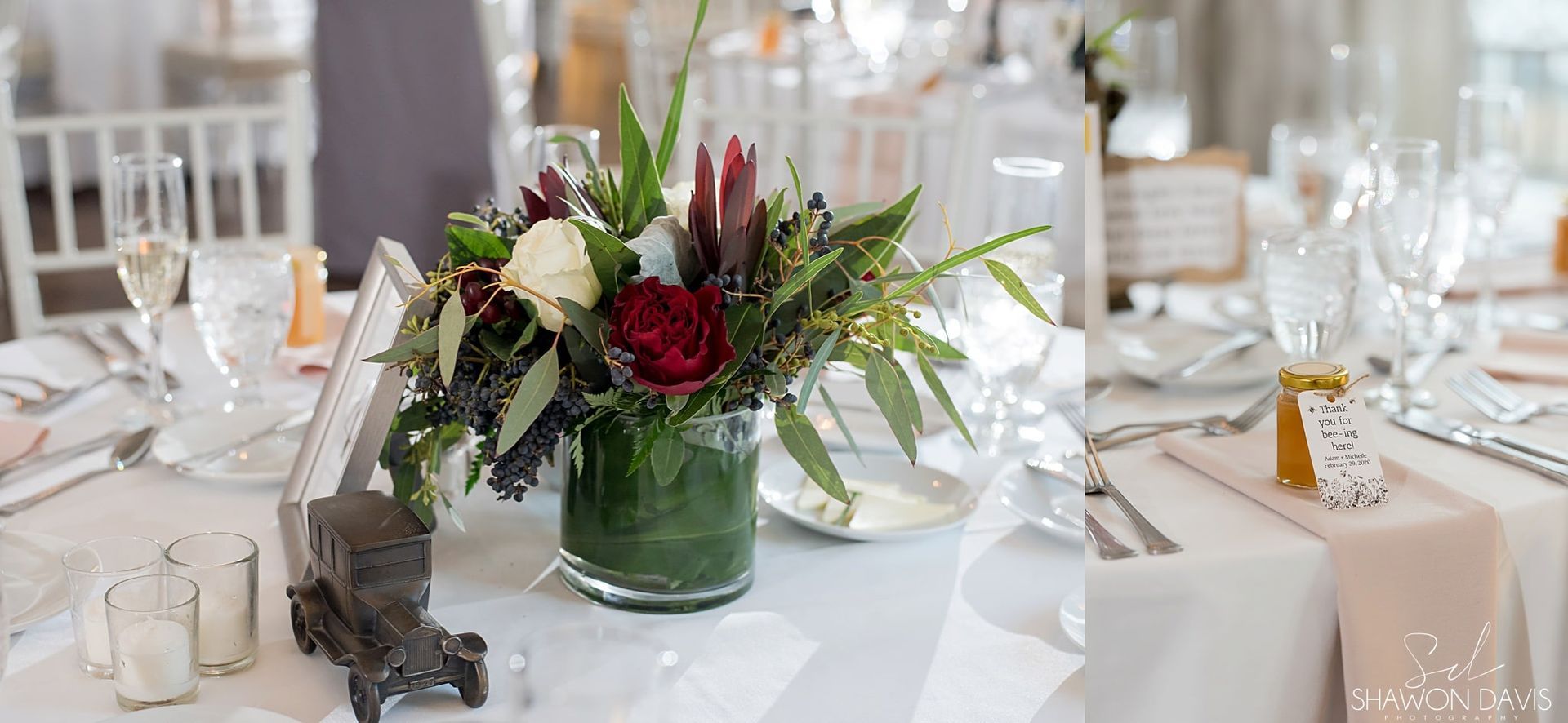 Elegant banquet table with white linens, glassware, and a green vase centerpiece of red and white flowers.