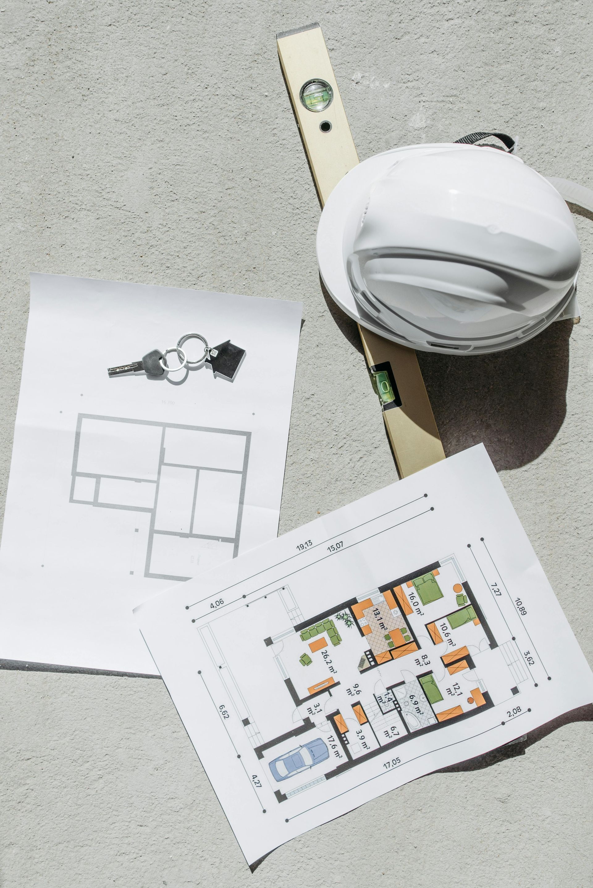 Two men are working on a ceiling in a bathroom.