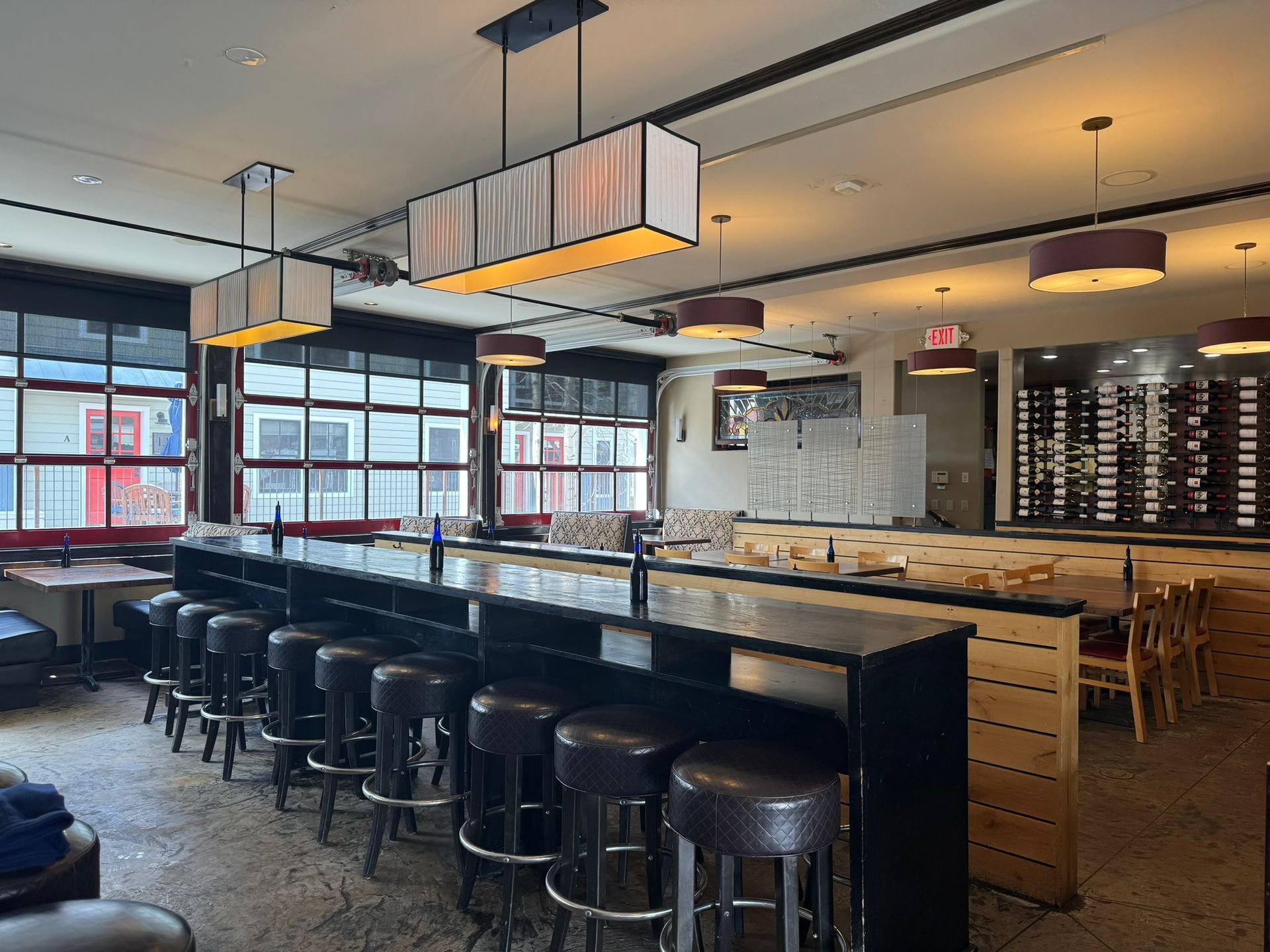 A restaurant with a long bar and stools