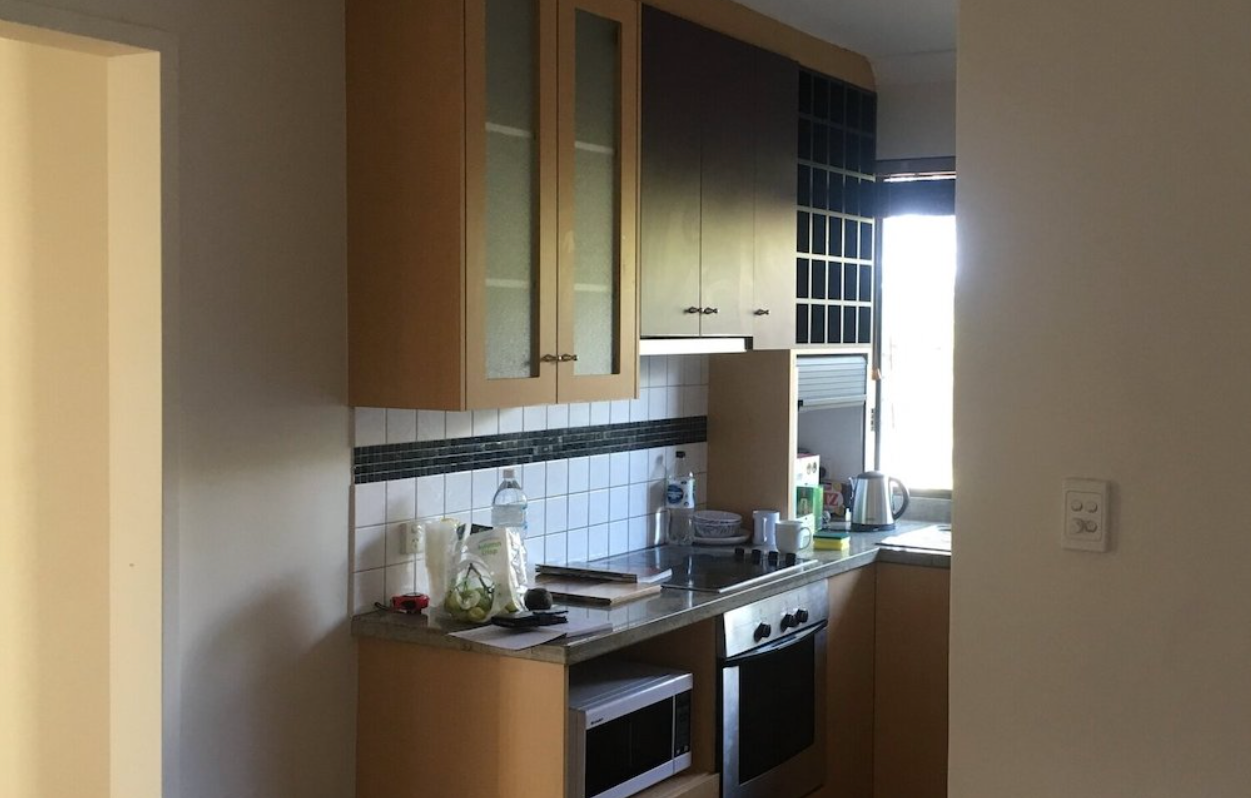 A kitchen with stainless steel appliances and wooden cabinets