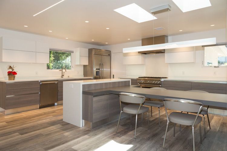 A kitchen with a table and chairs in it