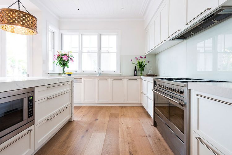 Galley kitchen with wooden flooring