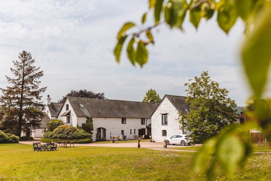 The lawns of the wedding venue showing the cottages in the background