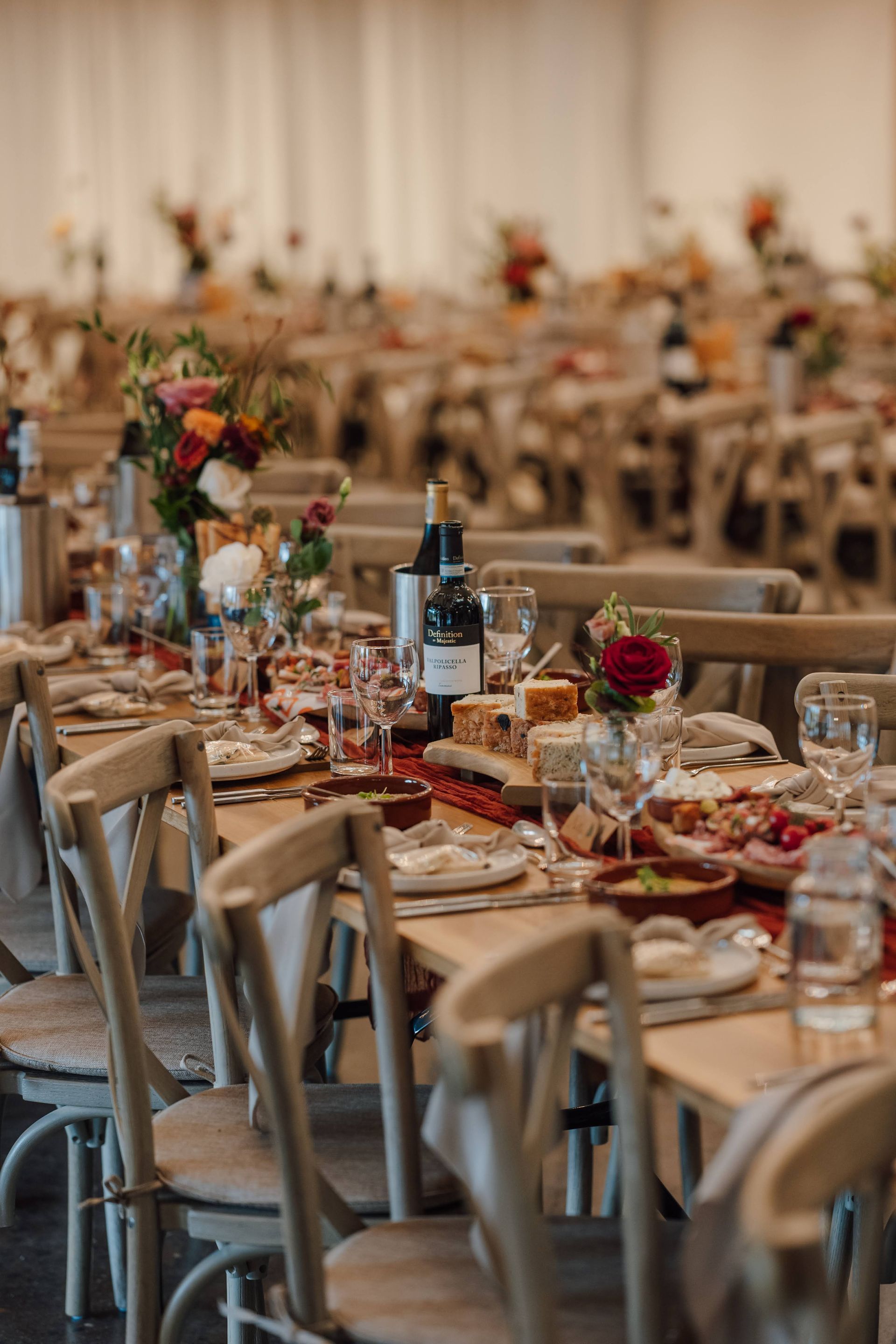 a table decorated with bamboo plates and sharing platters for the wedding breakfast