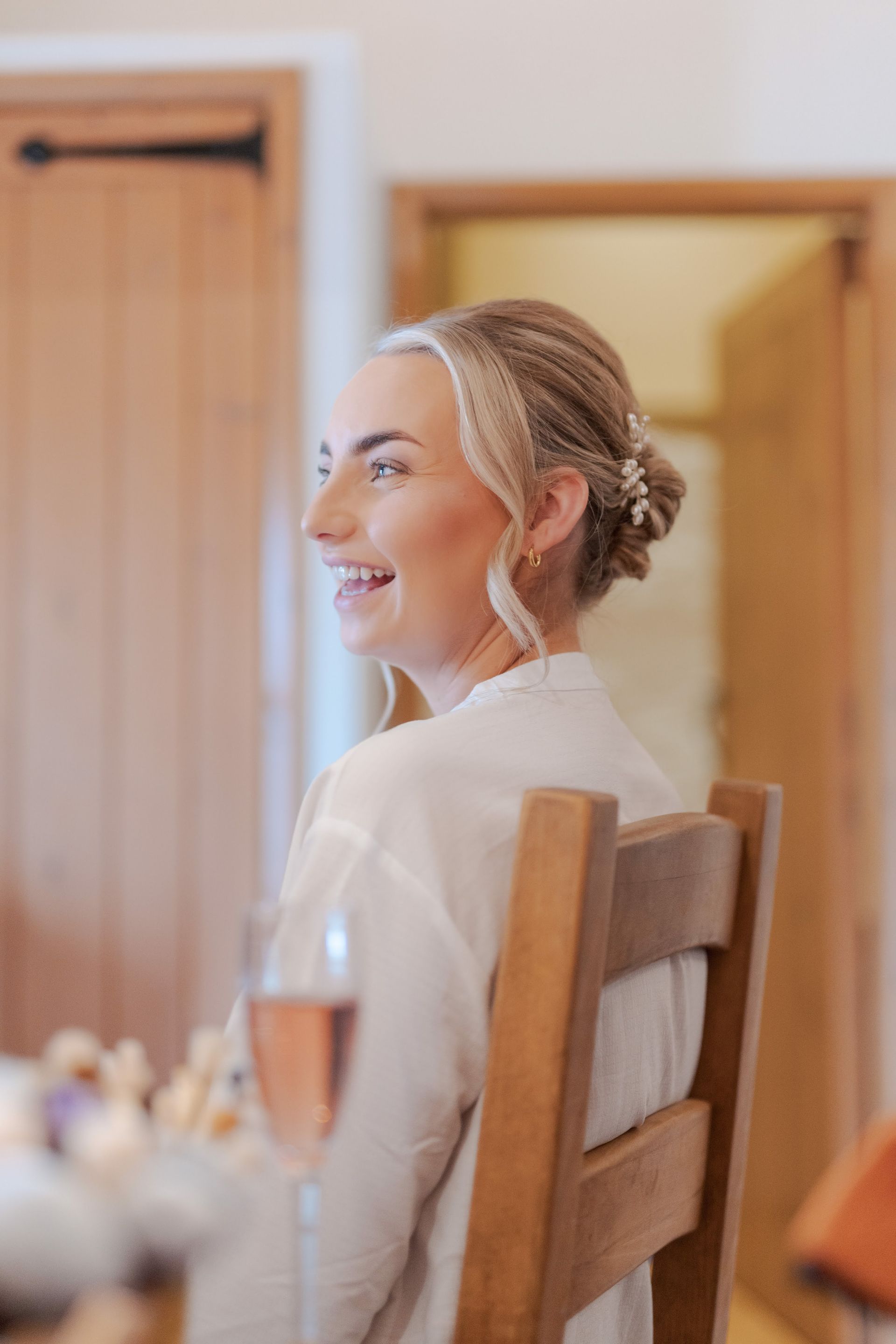 A bride having her make up done the morning of the wedding in the on site cottages