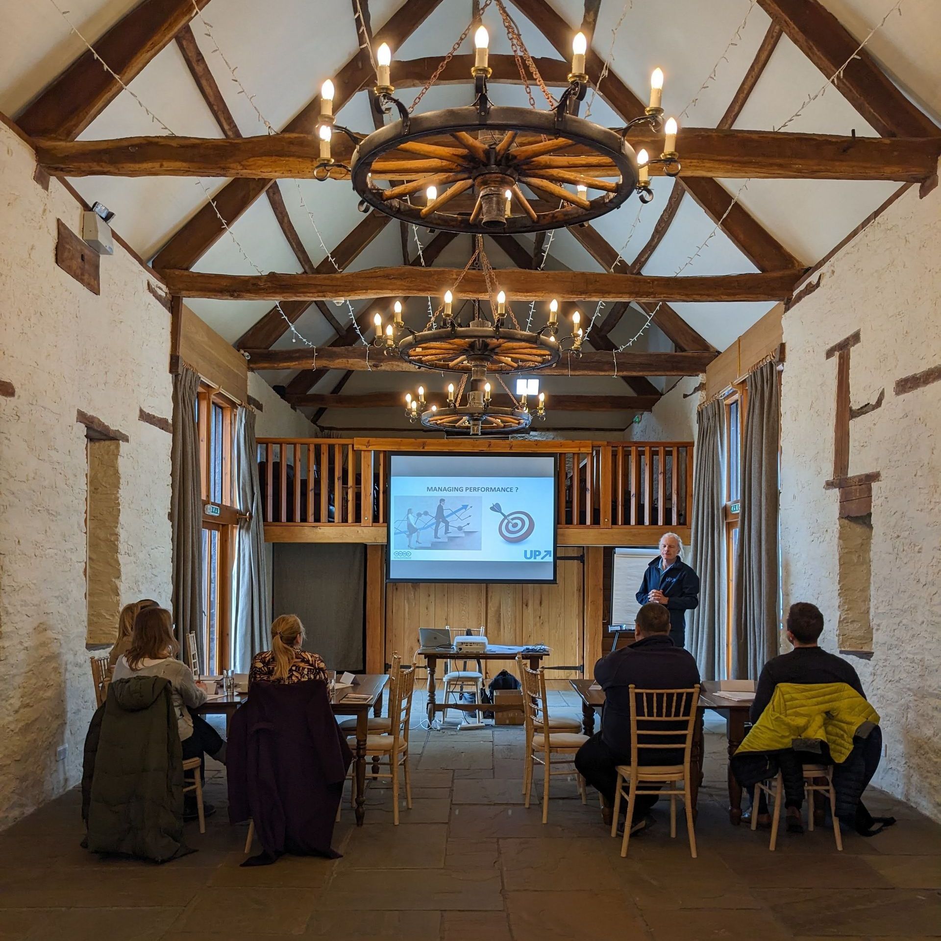 Meeting space in Brecon - Barn at Brynich, tables and chairs layout projector and screen