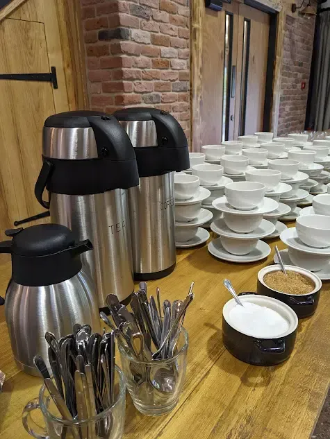 Coffee and Tea flasks with cups and sauces for a meeting