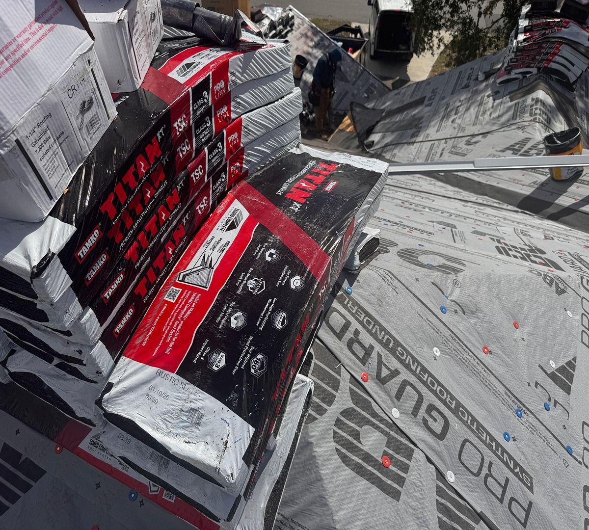 Stacked red-and-black boxing gear boxes on a tarp in a warehouse or loading area