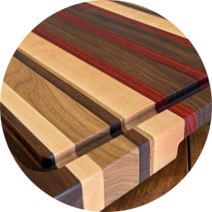 Wooden cutting board with striped wood grain and rounded corners