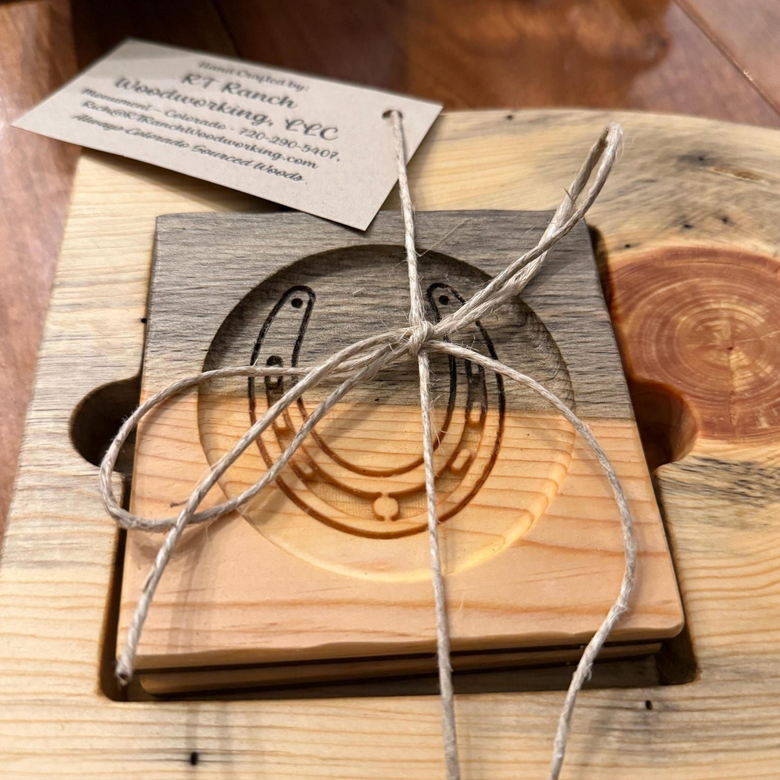 Wooden carved coaster tied with twine, with a small business tag on a wood table.